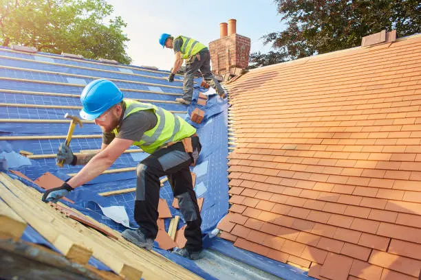 Insurance Claim 4 Roofer nailing roof tiles