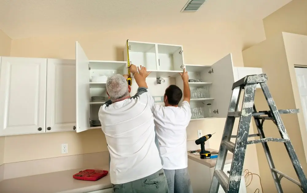 General Contractors Ayden NC 3 Two workers installing kitchen wall cabinets