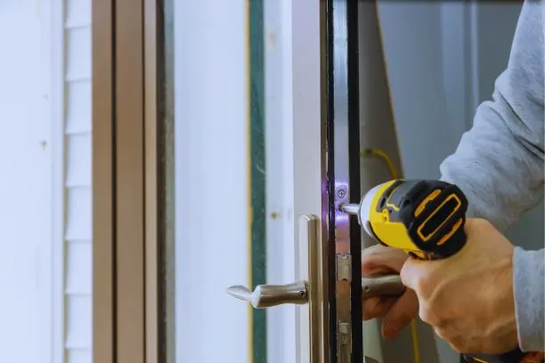 Home 10 Technician installing a door with a power drill