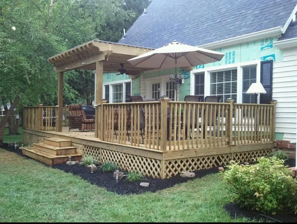 General Contractors Ayden NC 12 Wood deck with a pergola and railing behind a home