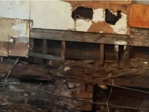 Water-damaged floor joists and subfloor seen from a crawl space