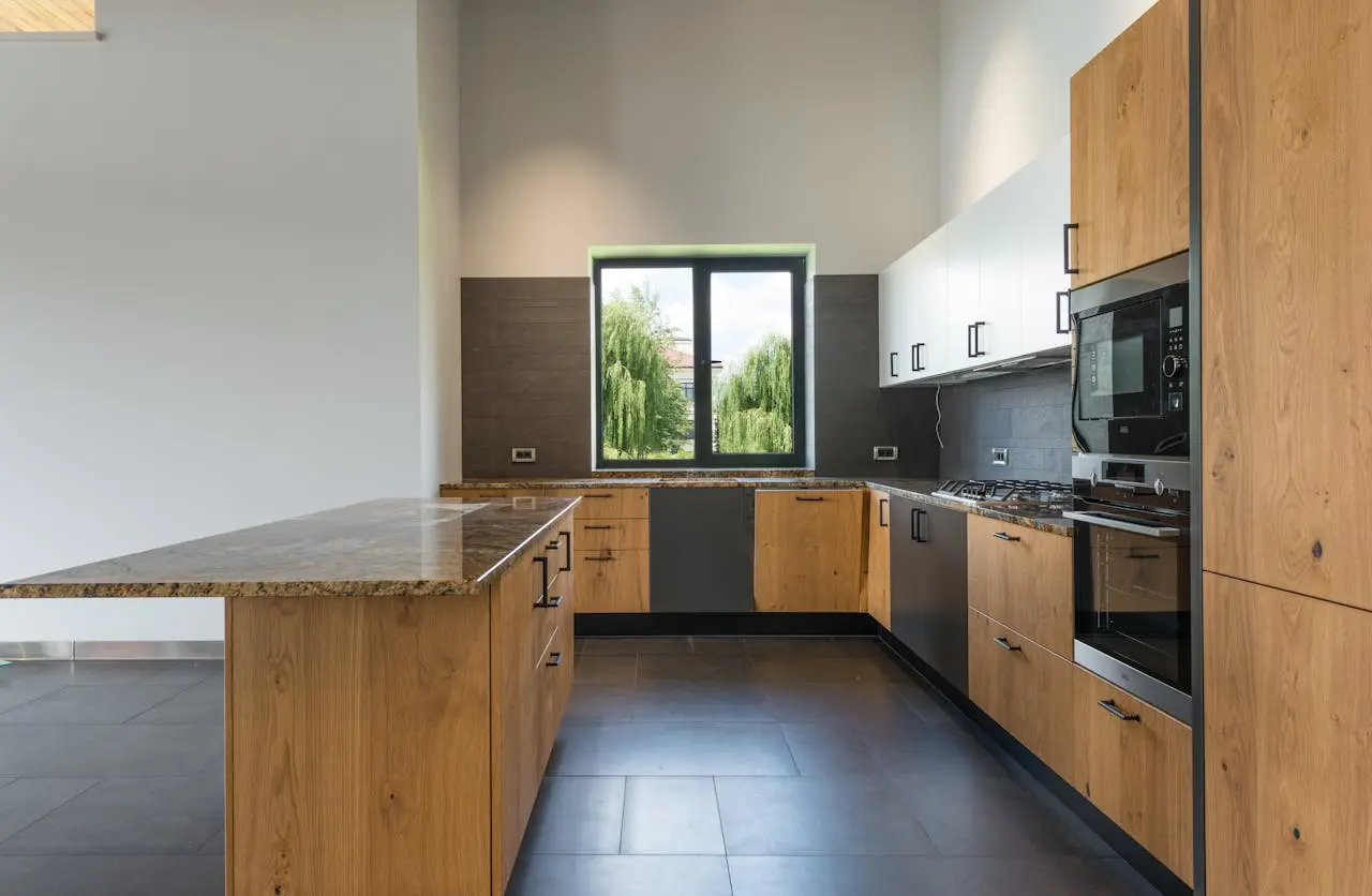 Modern kitchen with wood cabinets and a large window