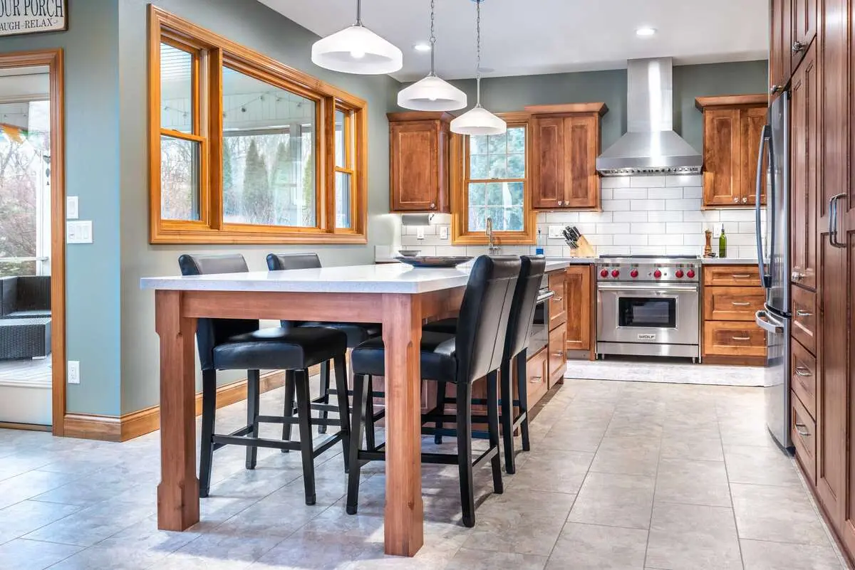 Remodeled kitchen with an island and wood cabinets in Greenville, NC