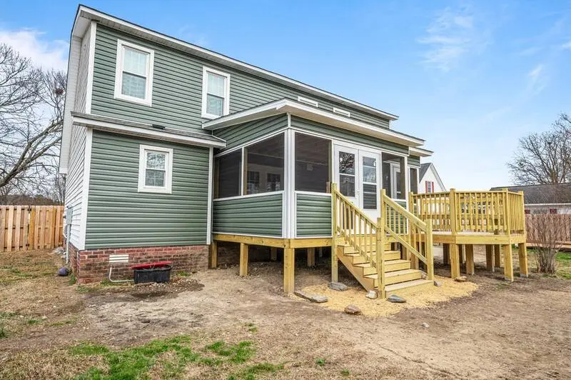 Home Addition in Winterville NC 2 Home with green siding and a screened porch with new deck stairs