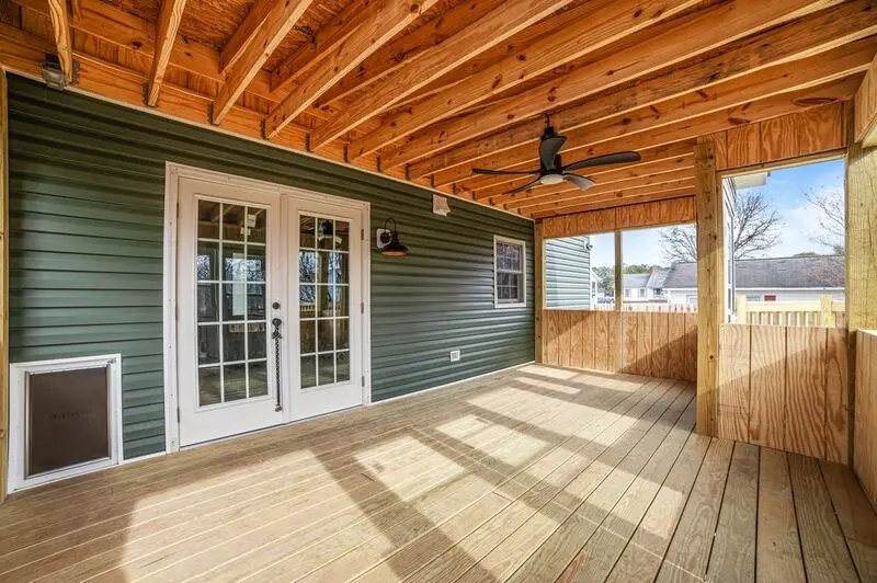 Home Addition in Winterville NC 1 Screened porch with green siding, French doors and a wood floor
