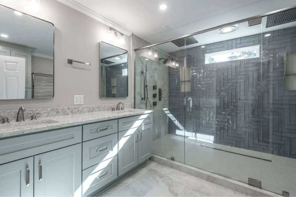 Home 6 Remodeled bathroom with a double vanity and glass shower